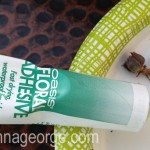 Squirt a small spot of floral adhesive onto a paper plate.