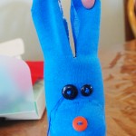 To create the ears, cut a slit in the top of the sock. Ears can then flop down or you can tie a piece of embroidery floss around them to make them stand up as we did with blue dog.